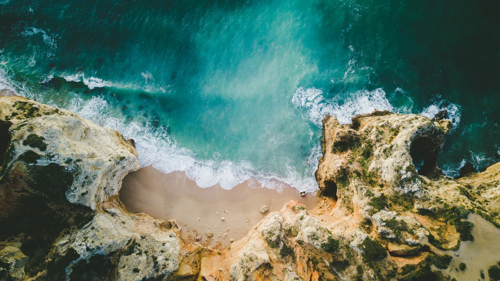 Golden cliffs meeting the turquoise Atlantic in Albufeira